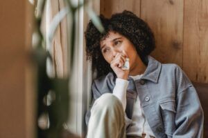 Woman Sitting In Window Crying